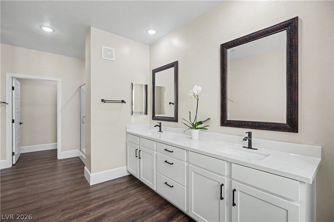 2555 Hampton Road, #11210, Henderson, NV 89052 Storage is easy in this spacious primary bath with abundant cabinetry, recessed lighting and on trend black fixtures.