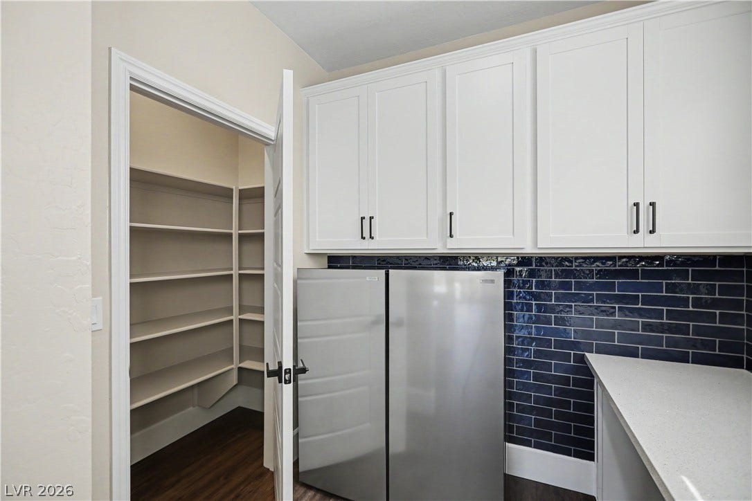 2555 Hampton Road, #11210, Henderson, NV 89052 Just off the kitchen, a walk-in pantry with wrap around shelving that keep groceries and kitchen essentials organized and out of sight. Plus two convertible stainless refrigerator/freezers are included in the sale.