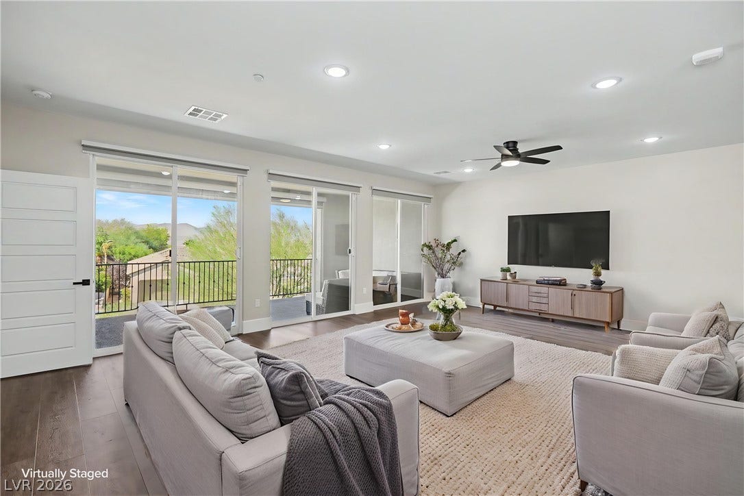 2555 Hampton Road, #11210, Henderson, NV 89052 Picture cozy movie nights and relaxed weekends in this inviting living room, with room for oversized seating and views of the mountains beyond the balcony.