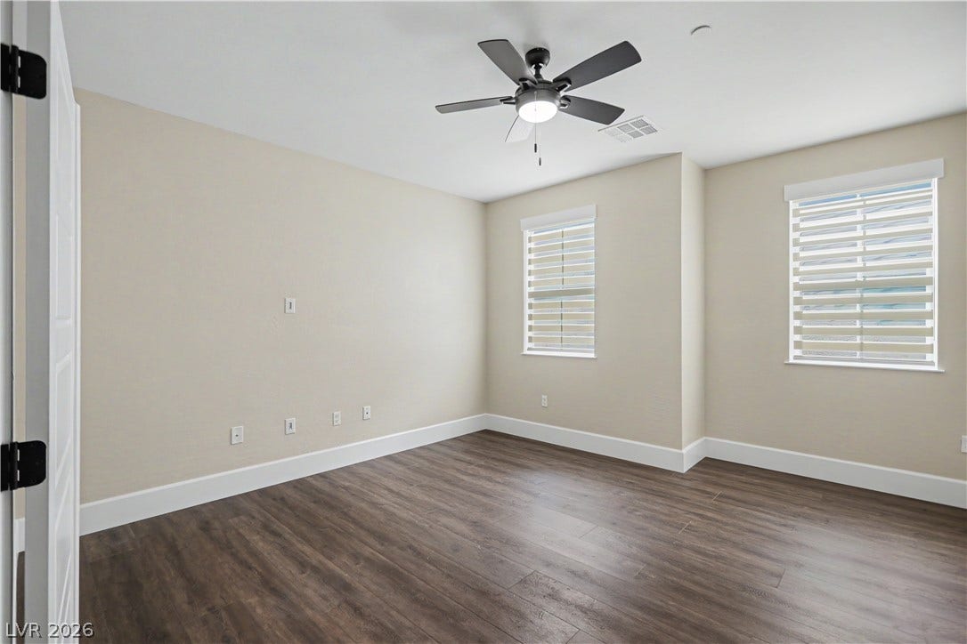 2555 Hampton Road, #11210, Henderson, NV 89052 Rich LVP flooring and crisp white trim enhance this sunlit room.