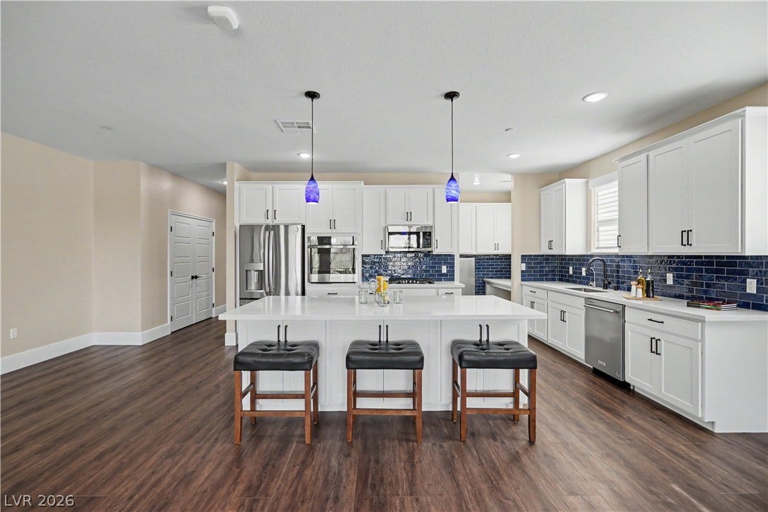 2555 Hampton Road, #11210, Henderson, NV 89052 Storage is never an issue here, with tons of cabinet space throughout, extra cabinets under the island, and expansive quartz counters that keep the kitchen flowing effortlessly.