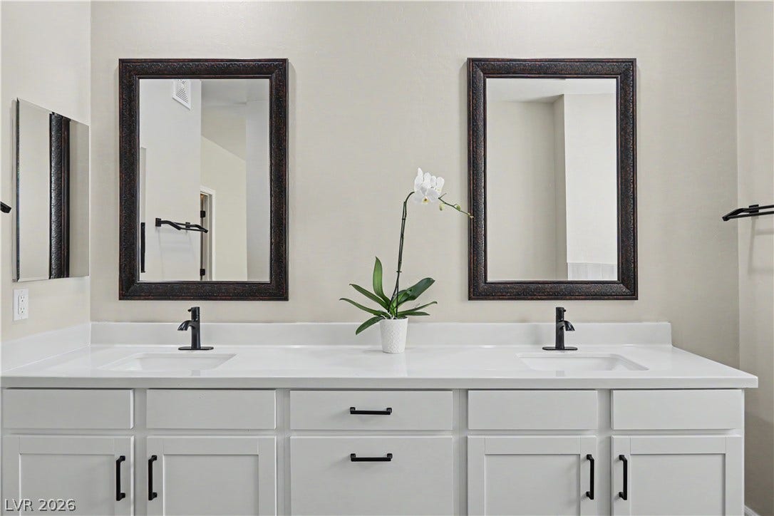 2555 Hampton Road, #11210, Henderson, NV 89052 Dual undermount sinks integrate seamlessly into the clean-lined vanity topped with stone counters.