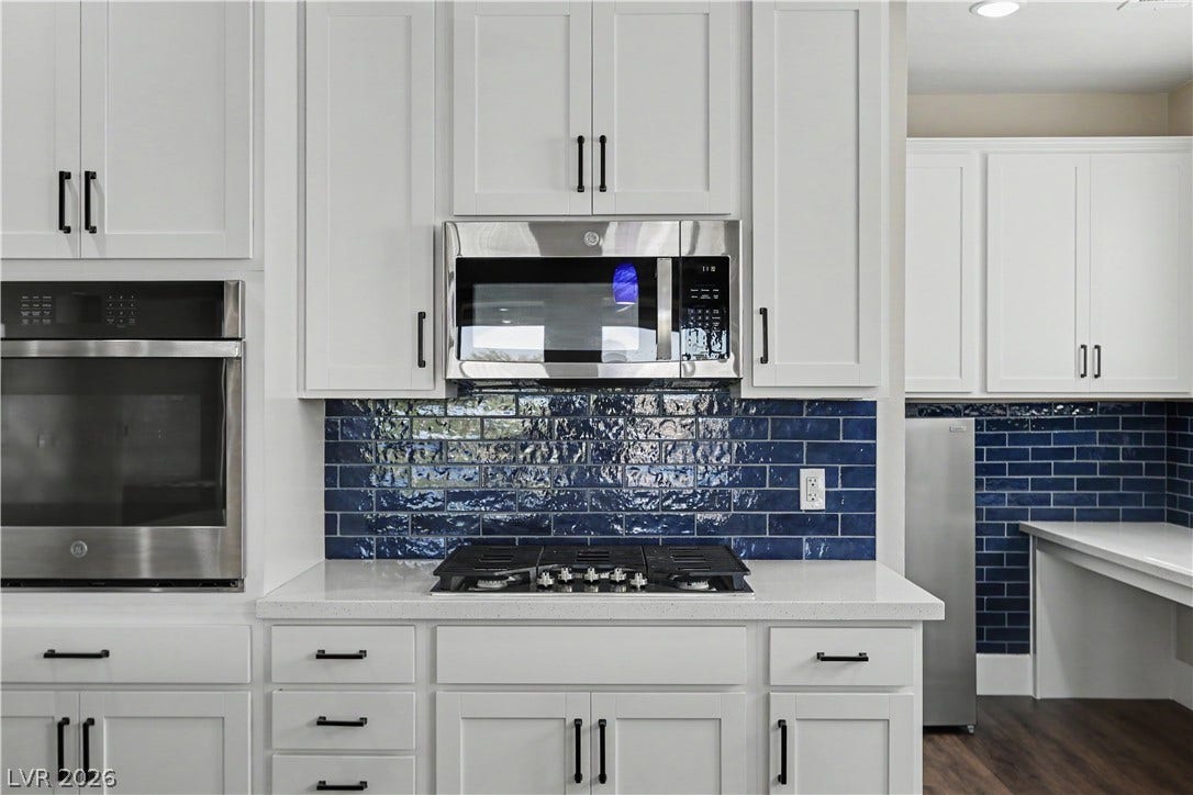 2555 Hampton Road, #11210, Henderson, NV 89052 The handcrafted-look navy tile adds texture and personality, framing the gas cooktop perfectly.