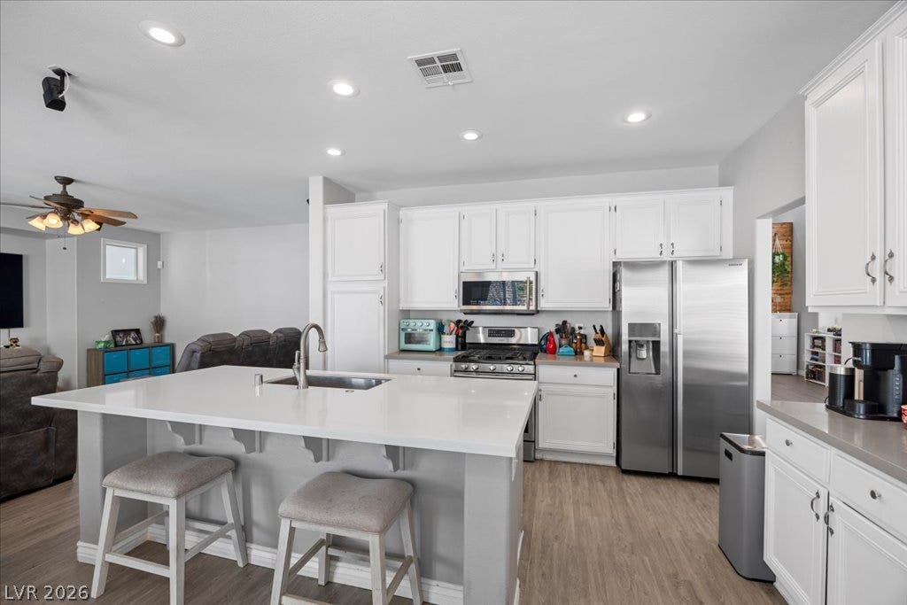 2386 Flute Avenue, Henderson, NV 89052 Gleaming stone countertops and matching cabinetry anchor this modern culinary space.