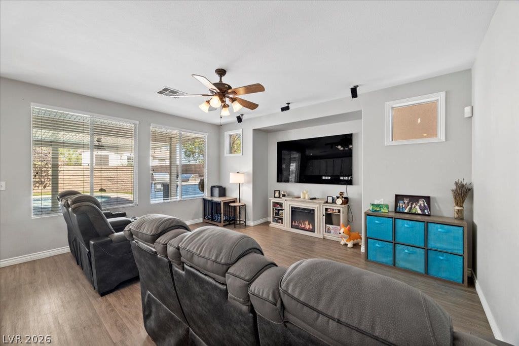 2386 Flute Avenue, Henderson, NV 89052 Smooth hard-surface flooring anchors this welcoming living space illuminated by large windows and recessed lighting.