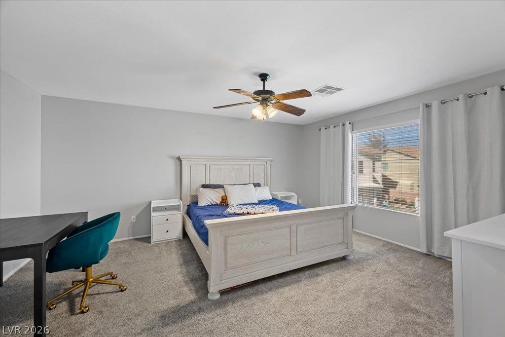 2386 Flute Avenue, Henderson, NV 89052 Plush carpeting underfoot and abundant natural light create a serene and relaxing bedroom atmosphere.