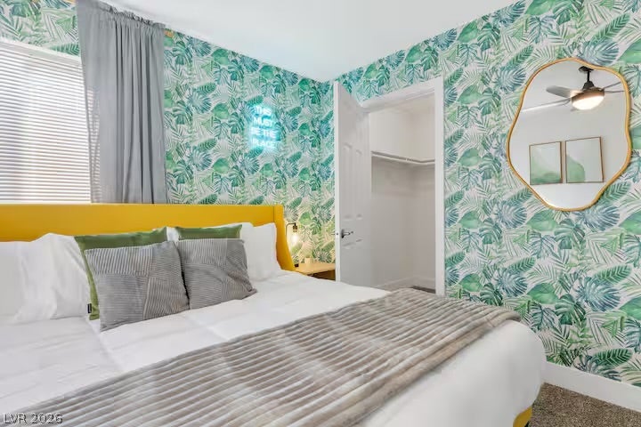 2713 Concord Street, North Las Vegas, NV 89030 Bold leaf-patterned walls pair with soft carpeted floors in this cozy bedroom retreat.