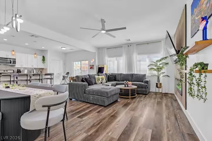 2713 Concord Street, North Las Vegas, NV 89030 Rich wood-inspired flooring anchors this open-concept layout connecting the main living and dining spaces.