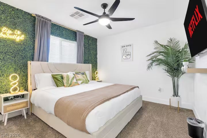 2713 Concord Street, North Las Vegas, NV 89030 Plush carpeting and a wide window create a comfortable, inviting atmosphere in this bedroom.