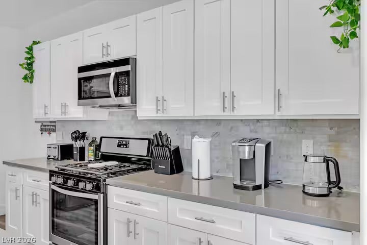 2713 Concord Street, North Las Vegas, NV 89030 Smooth solid countertops pair beautifully with classic white shaker cabinetry.