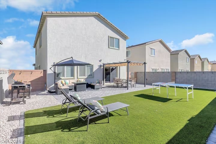 2713 Concord Street, North Las Vegas, NV 89030 A spacious backyard features a paved patio, a covered pergola, and low-maintenance turf grass.
