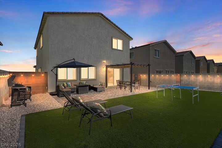 2713 Concord Street, North Las Vegas, NV 89030 A spacious stone patio and lush green lawn define this inviting outdoor living space.