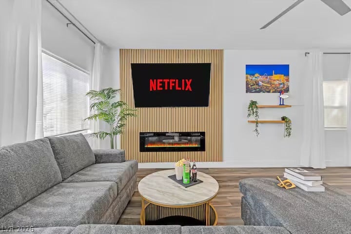 2713 Concord Street, North Las Vegas, NV 89030 A modern fireplace is set into a wood slat wall paneling in this living space.