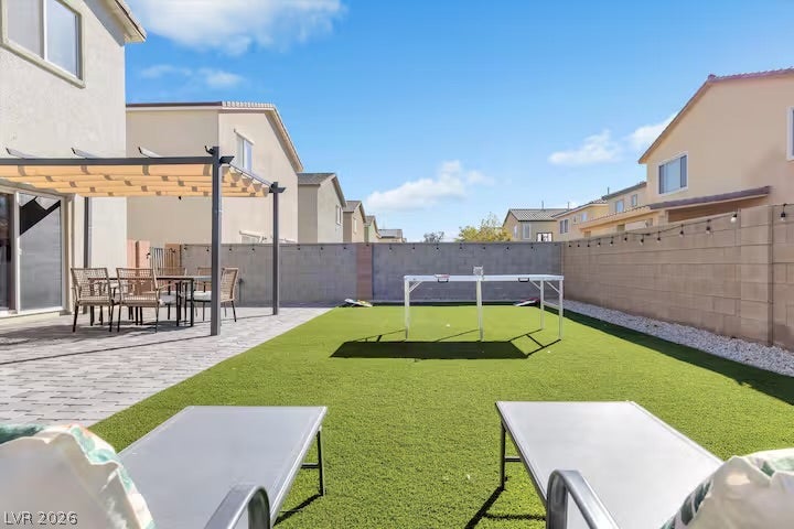 2713 Concord Street, North Las Vegas, NV 89030 An enclosed backyard features a stone paver patio and low-maintenance turf lawn.
