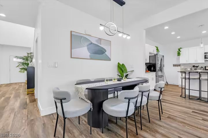 2713 Concord Street, North Las Vegas, NV 89030 An open dining area flows seamlessly into the kitchen over rich wood floors.