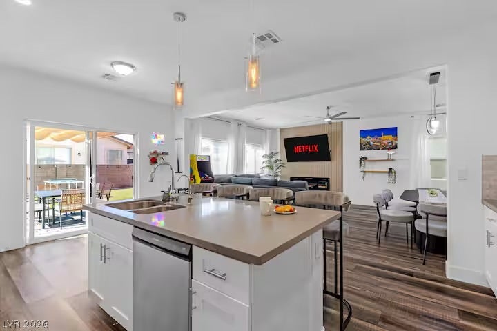 2713 Concord Street, North Las Vegas, NV 89030 Gleaming stone countertops and a spacious breakfast bar highlight this open-concept kitchen space.
