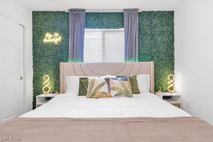 2713 Concord Street, North Las Vegas, NV 89030 A bright window naturally illuminates this cozy bedroom space.