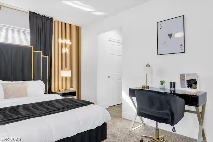 2713 Concord Street, North Las Vegas, NV 89030 A spacious bedroom features neutral walls and plush carpet flooring throughout.