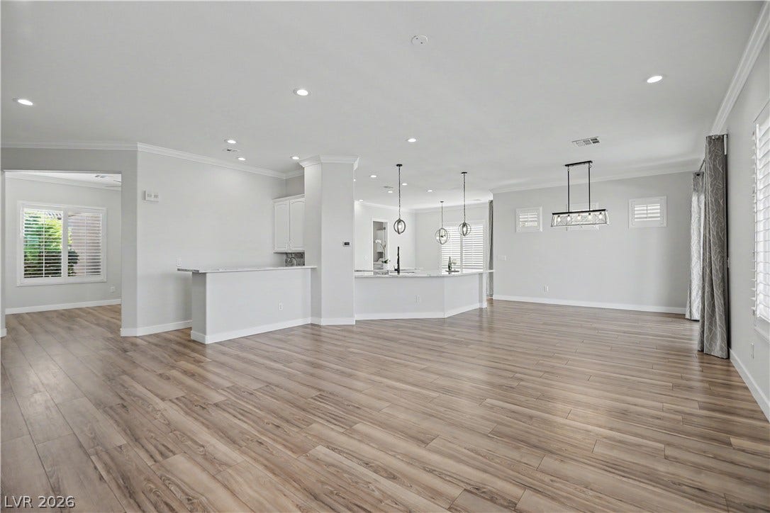2073 Fountain City Street, Henderson, NV 89052 From the living room to the kitchen and dining area, this open floor plan is made for gathering, with designer lighting and wood-look laminate flooring throughout.