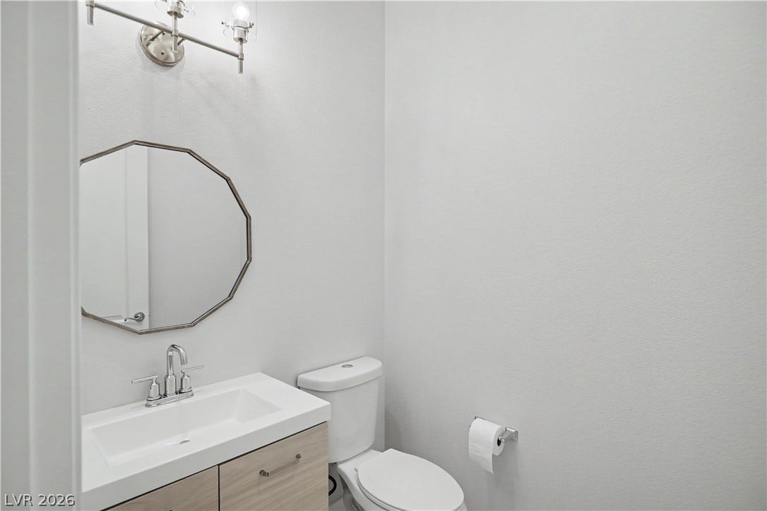 2073 Fountain City Street, Henderson, NV 89052 Guests will love this stylish half bath, with a contemporary vanity, a sleek light fixture and a statement mirror.
