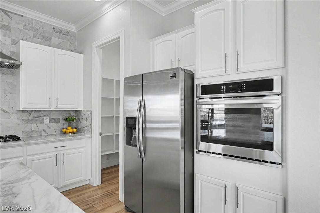 2073 Fountain City Street, Henderson, NV 89052 Convenience is built right in with a wall oven at an easy height, a stainless refrigerator and floor-to-ceiling cabinetry.