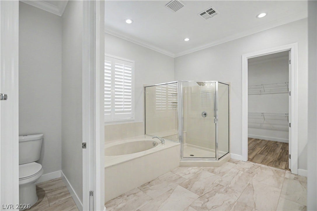 2073 Fountain City Street, Henderson, NV 89052 Everything you need in a primary bath: a soaking tub, separate shower, private water closet and a walk-in closet with plenty of hanging space.