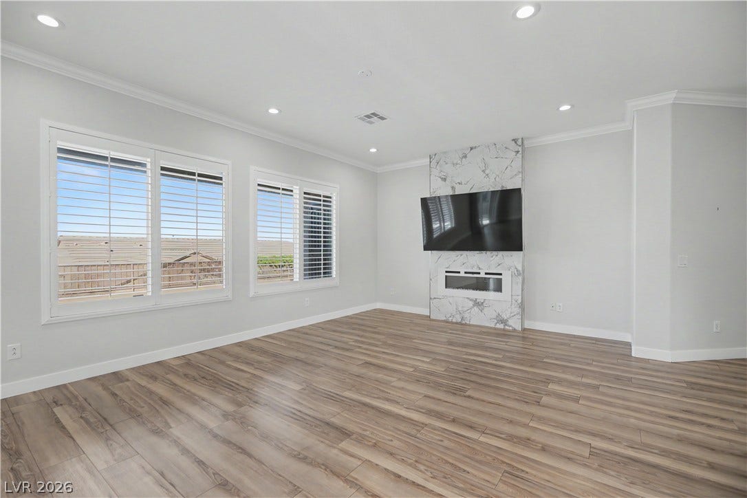 2073 Fountain City Street, Henderson, NV 89052 The living room's showpiece is the custom floor to ceiling fireplace with a sleek linear electric fireplace and mounted TV, which will convey with the sale of the home.