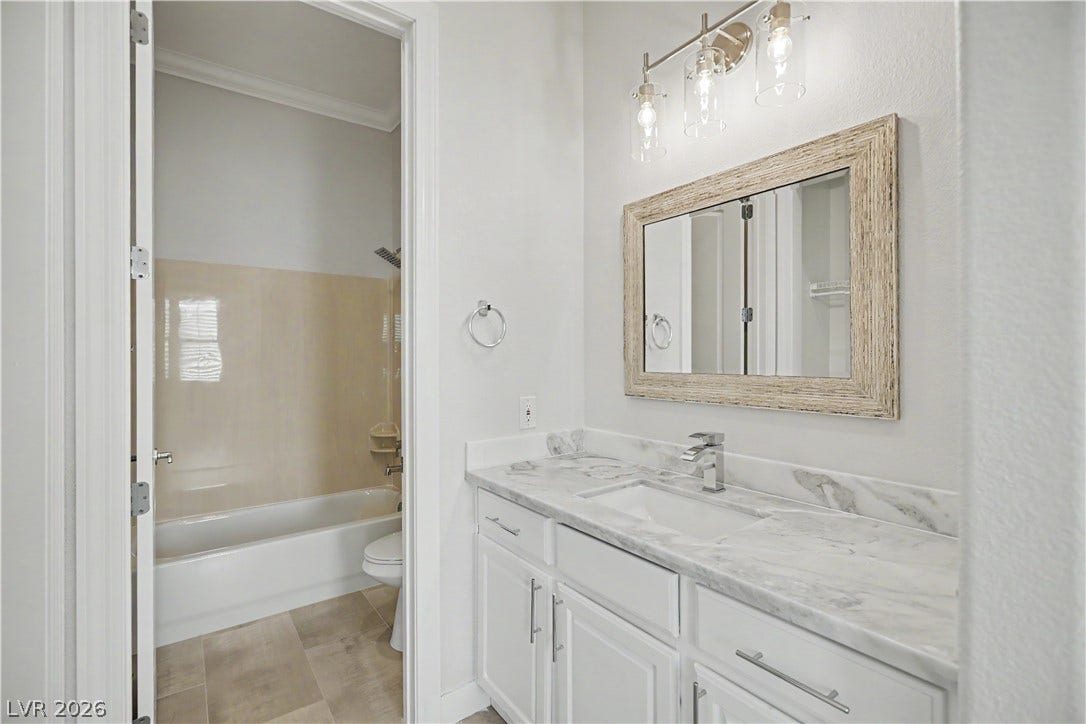2073 Fountain City Street, Henderson, NV 89052 The second bedroom's private en suite features a marble vanity top, modern glass light fixture and a separate water closet/tub/shower room.