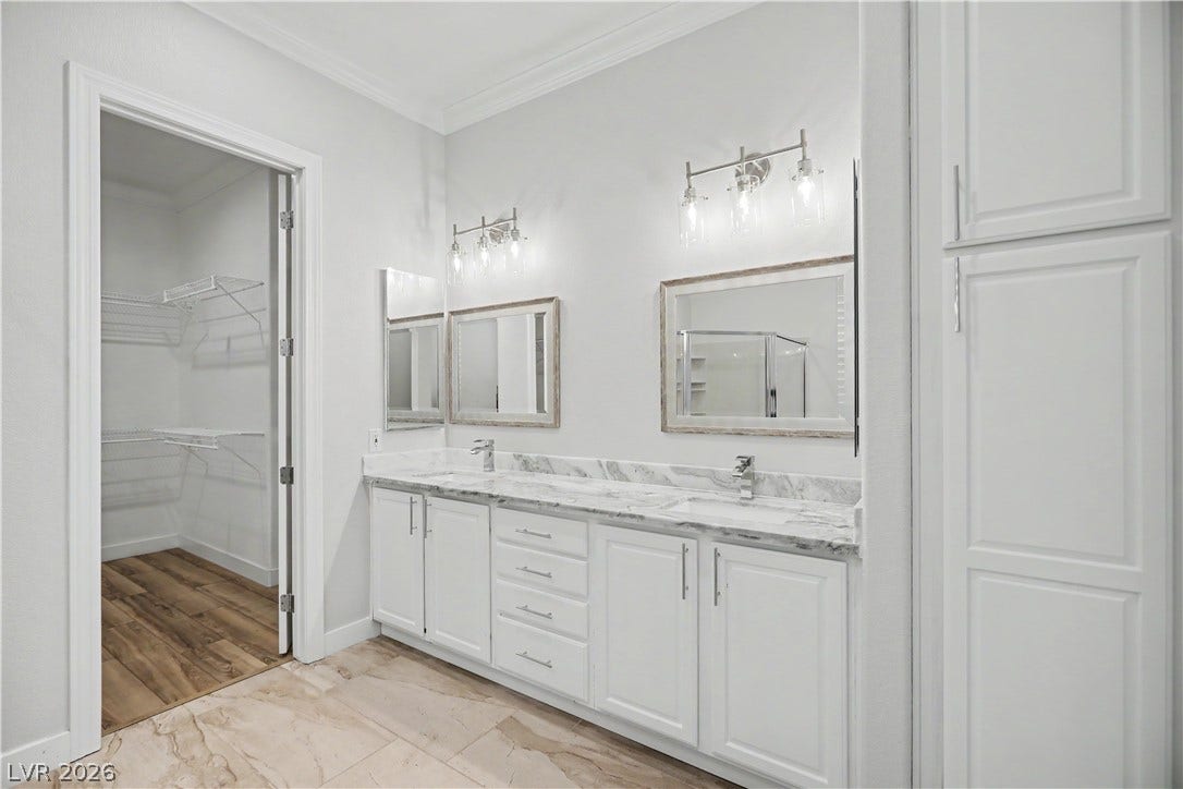 2073 Fountain City Street, Henderson, NV 89052 Storage is everywhere you look from the dual vanity's deep drawers to a tall linen cabinet and the spacious walk-in closet.