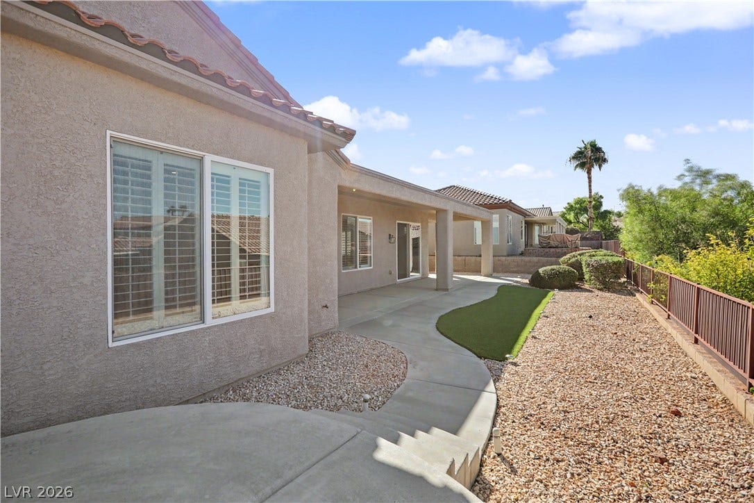 2073 Fountain City Street, Henderson, NV 89052 The low-maintenance backyard features desert landscaping, artificial turf, and wrought iron view fence that keeps the scenery wide open.