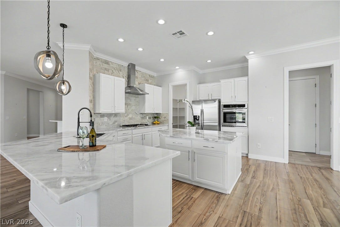 2073 Fountain City Street, Henderson, NV 89052 This chef-inspired kitchen offers two islands, a walk-in pantry, stainless appliances, and abundant white cabinetry with pull out shelves for all your storage needs.