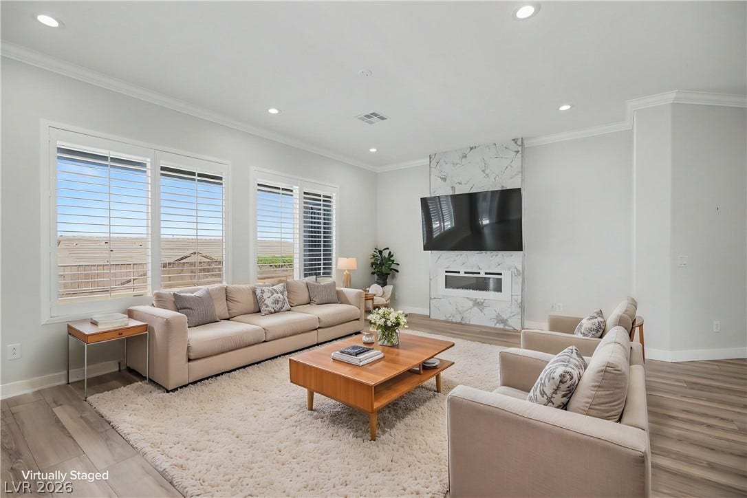 2073 Fountain City Street, Henderson, NV 89052 This bright living room has room for everyone, from game day gatherings to quiet nights by the electric fireplace.