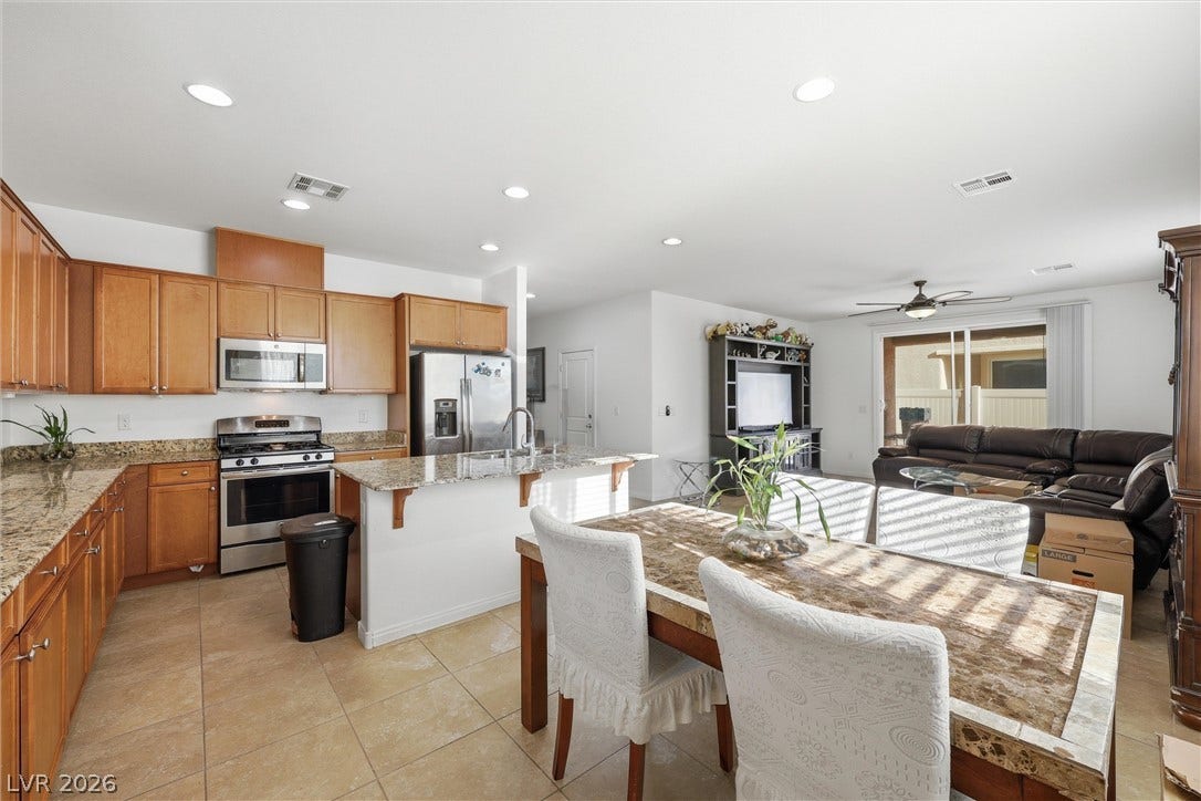 7057 Millers Run Street, North Las Vegas, NV 89084 An open floorplan seamlessly connects the kitchen and dining area to the living room.