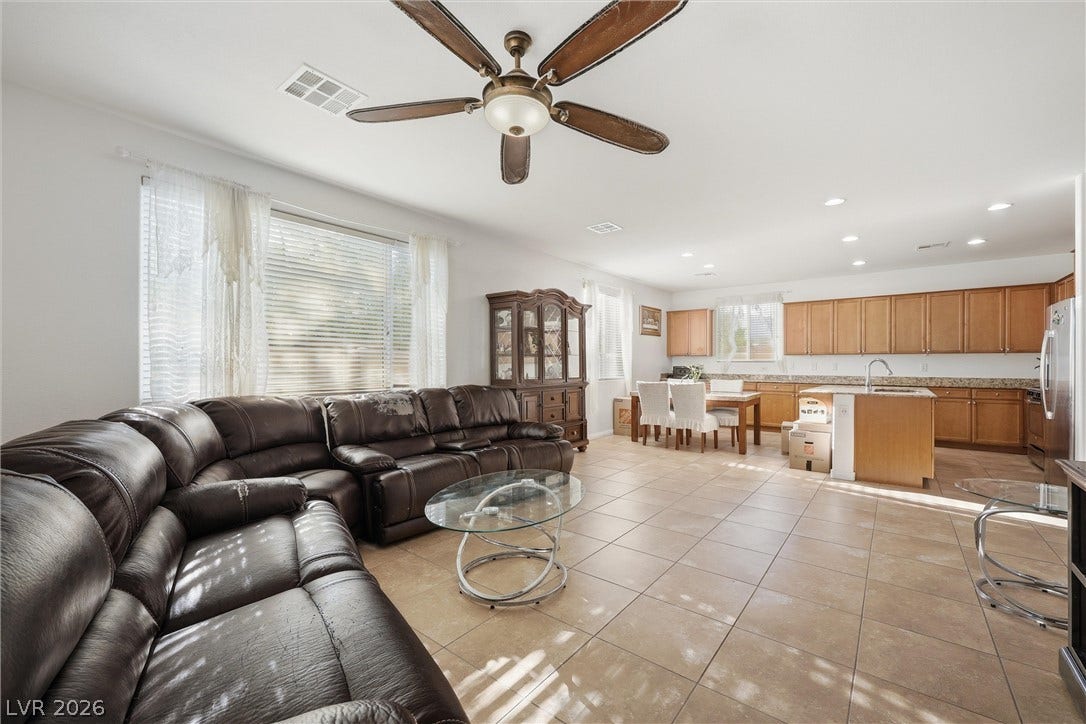 7057 Millers Run Street, North Las Vegas, NV 89084 Tiled flooring flows through this airy, open-concept living area and kitchen space.