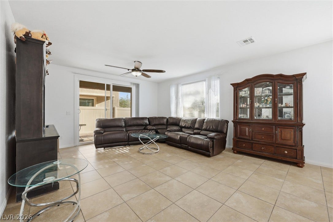 7057 Millers Run Street, North Las Vegas, NV 89084 Gleaming tile floors and sliding glass doors define this open living area.