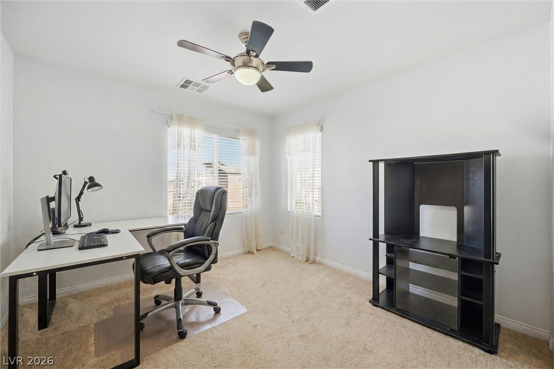7057 Millers Run Street, North Las Vegas, NV 89084 Plentiful natural light fills a versatile room finished with soft carpet.