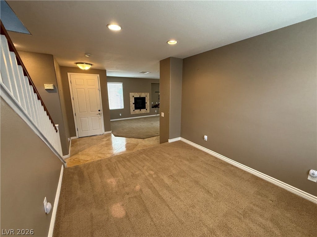 5904 Gold Horizon Street, North Las Vegas, NV 89031 An open floorplan connects the carpeted living space to the tiled entryway and staircase.