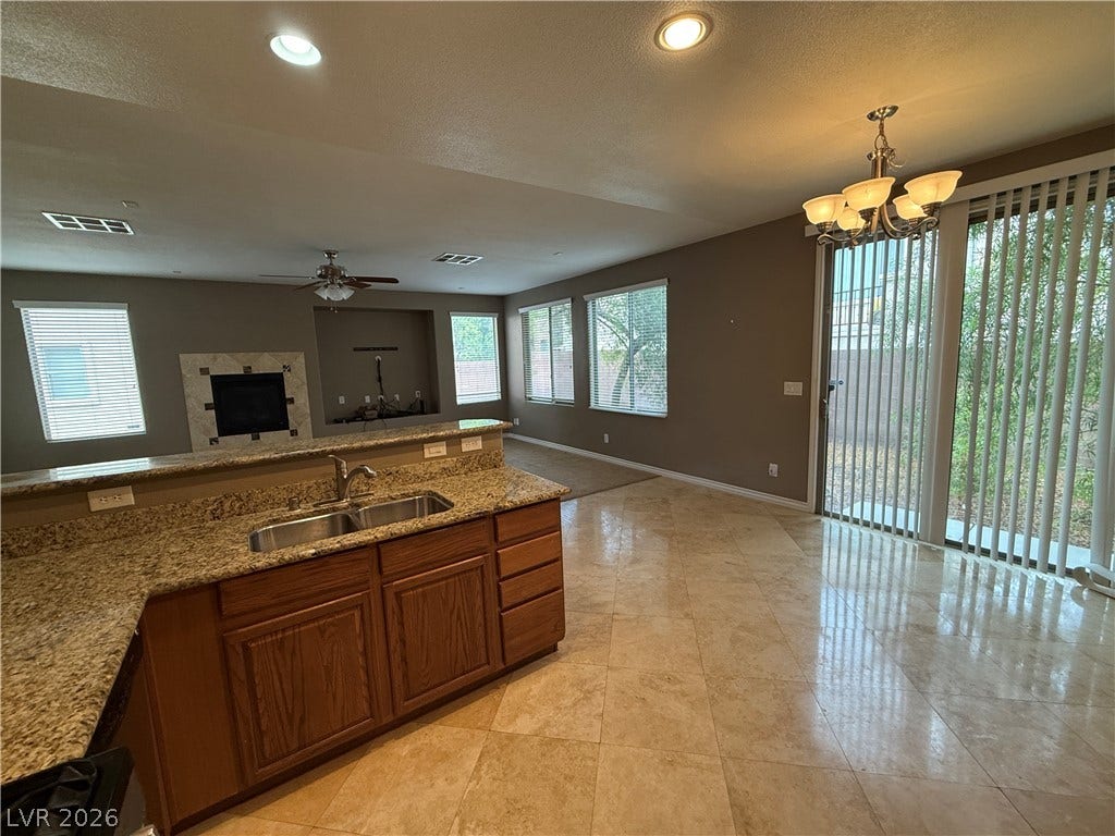 5904 Gold Horizon Street, North Las Vegas, NV 89031 Granite countertops and polished tile flooring elevate this functional open-concept layout.