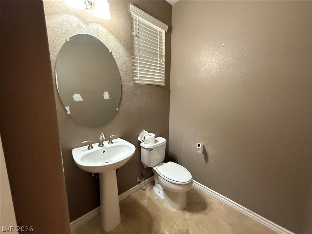 5904 Gold Horizon Street, North Las Vegas, NV 89031 An elegant pedestal sink and tile flooring define this classic powder room.