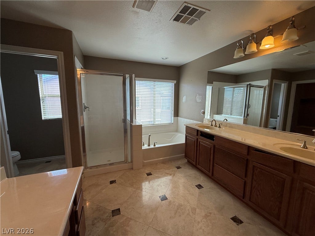 5904 Gold Horizon Street, North Las Vegas, NV 89031 Polished tile flooring accents this master bath featuring a dual sink vanity and soaking tub.