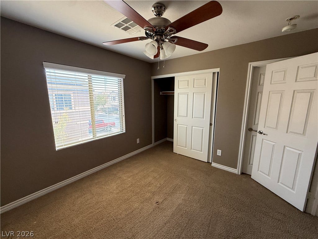 5904 Gold Horizon Street, North Las Vegas, NV 89031 Carpeted flooring and a wide window with integrated blinds highlight this secondary bedroom.