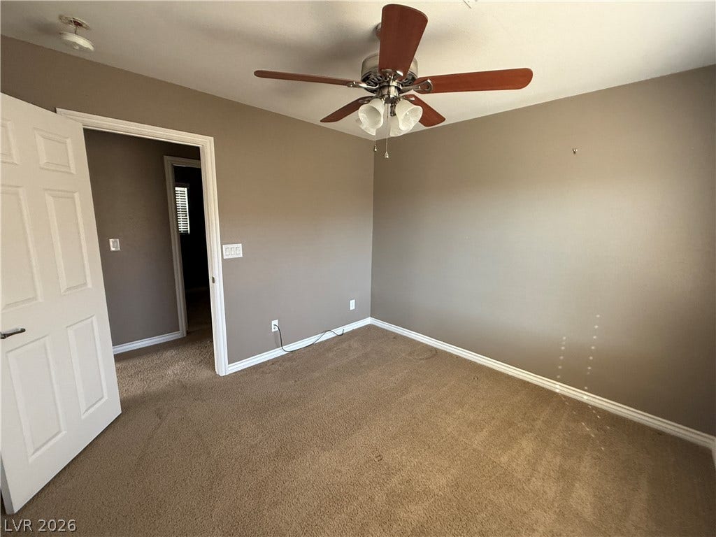 5904 Gold Horizon Street, North Las Vegas, NV 89031 Plush carpeting and classic baseboards anchor this versatile bedroom space.
