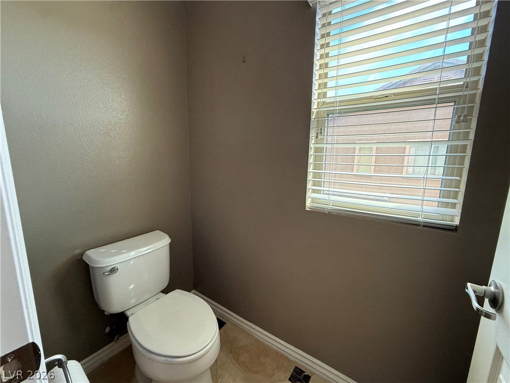 5904 Gold Horizon Street, North Las Vegas, NV 89031 Natural light pours through a large window, illuminating the private water closet.