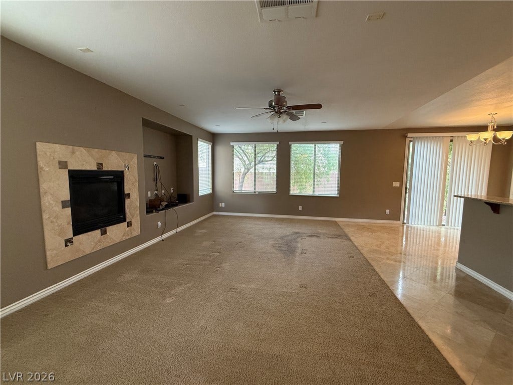 5904 Gold Horizon Street, North Las Vegas, NV 89031 An open living space features a tiled fireplace alongside an adjoining dining area.