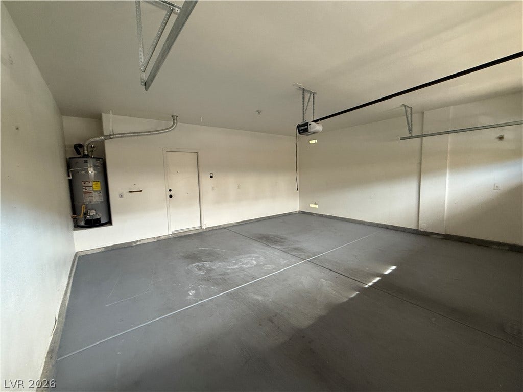 5904 Gold Horizon Street, North Las Vegas, NV 89031 Smooth concrete floors and finished walls define this functional attached garage space.