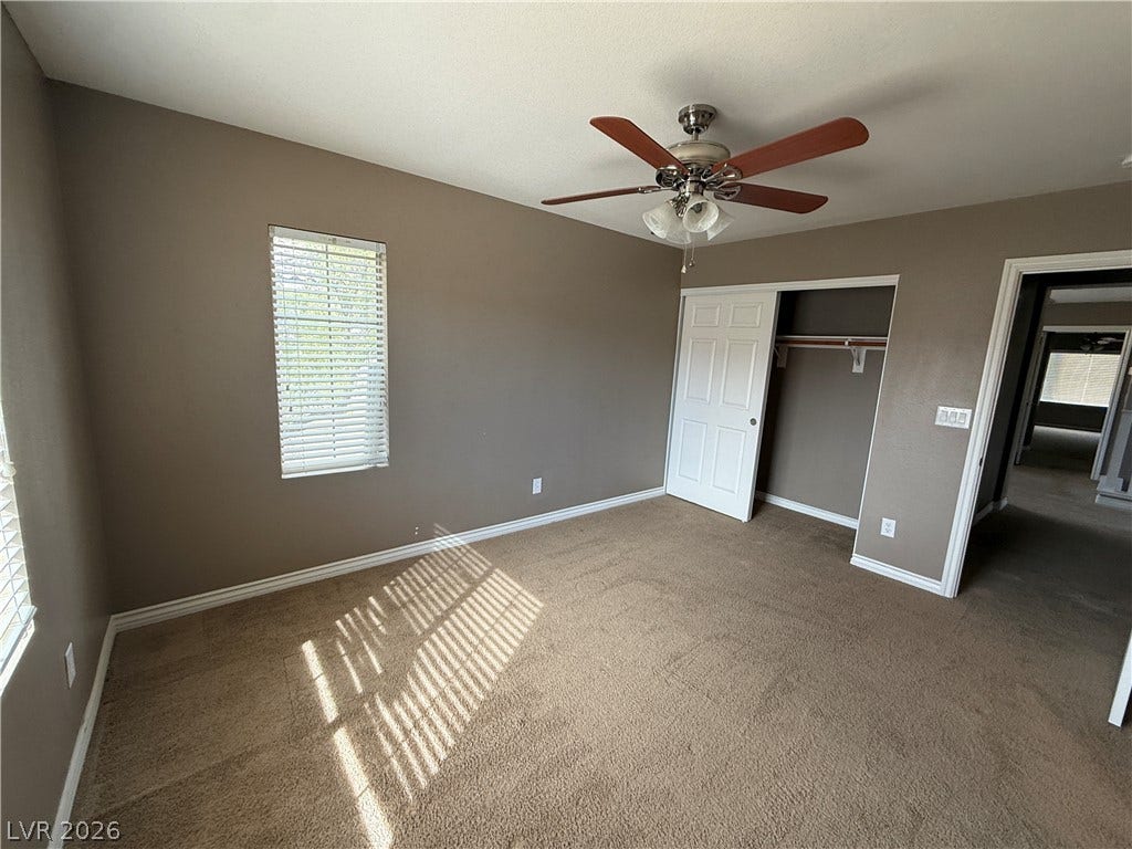 5904 Gold Horizon Street, North Las Vegas, NV 89031 Natural light streams through multiple windows onto the soft carpeted flooring of this room.