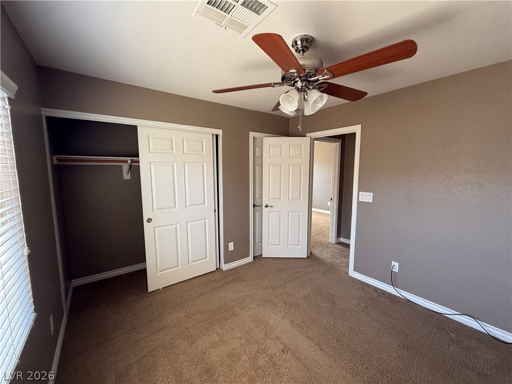 5904 Gold Horizon Street, North Las Vegas, NV 89031 Soft carpeting pairs with classic paneled doors in this comfortable room.