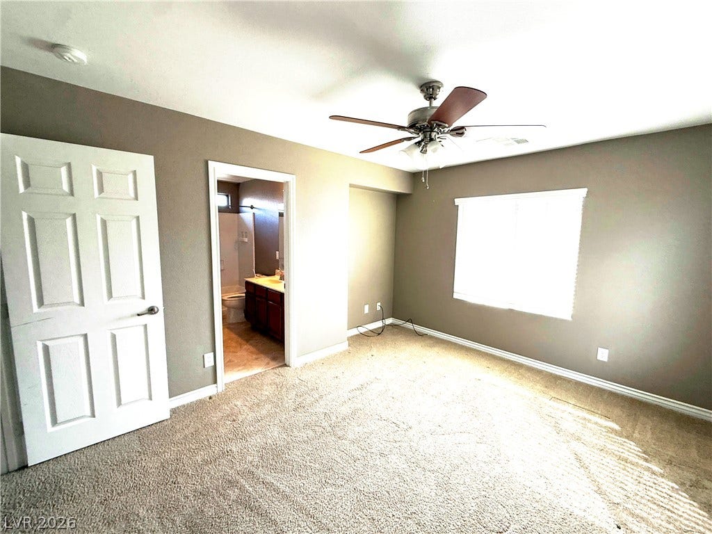 5904 Gold Horizon Street, North Las Vegas, NV 89031 Plush carpeting and an en suite bathroom access anchor this comfortable bedroom retreat.