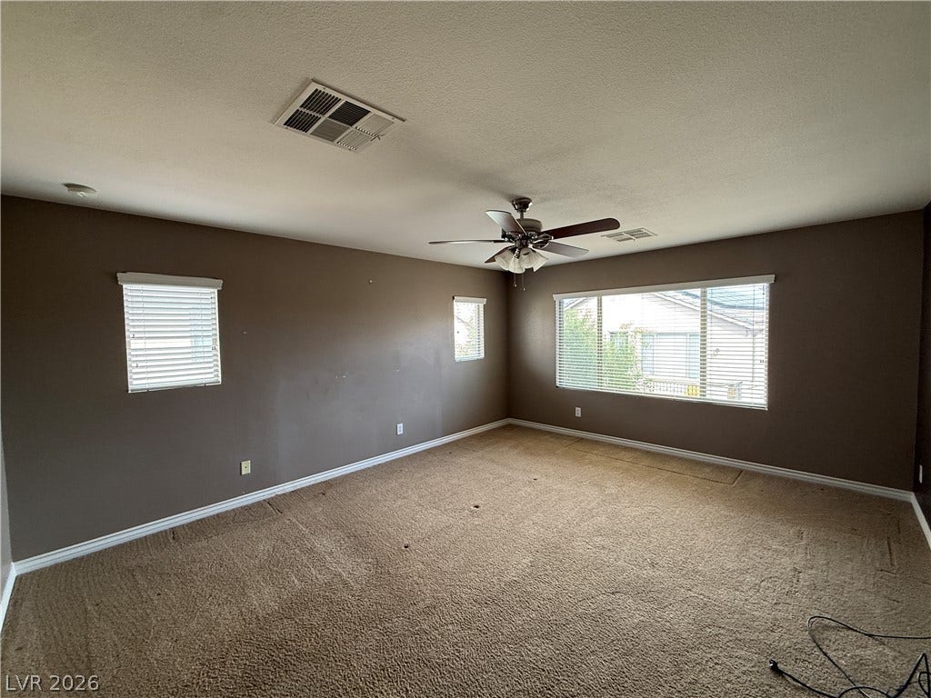 5904 Gold Horizon Street, North Las Vegas, NV 89031 Generous window openings and textured carpeting anchor this versatile secondary bedroom space.