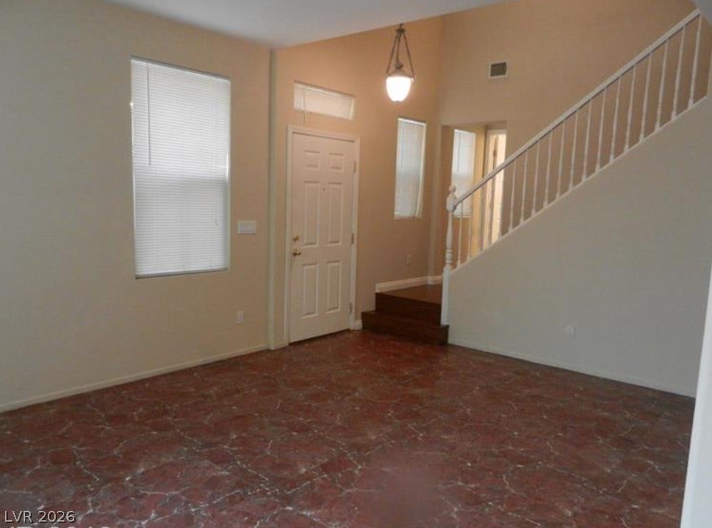 4421 Oberlander Avenue, North Las Vegas, NV 89031 A spacious entryway features high ceilings, tile flooring, and an open staircase.
